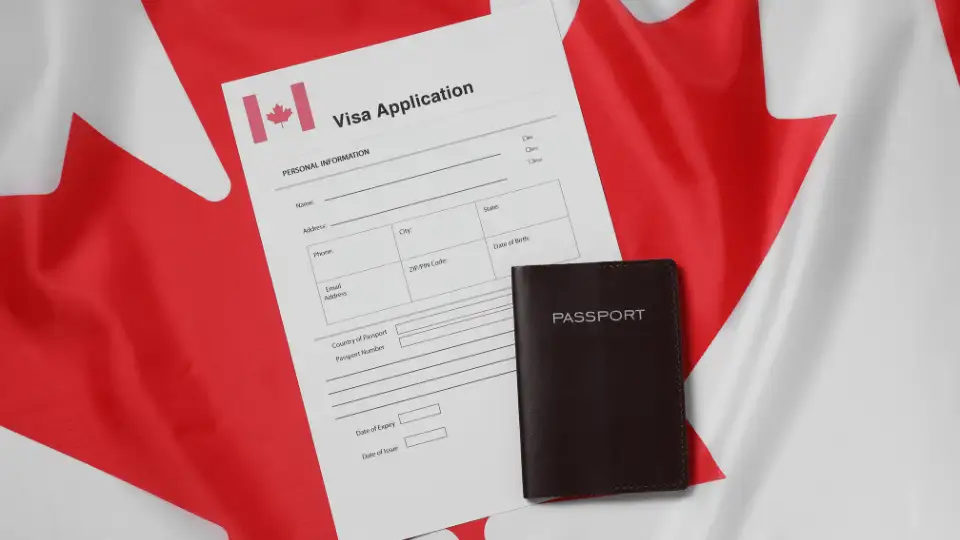 Canadian flag and immigration documents with delayed processing stamp