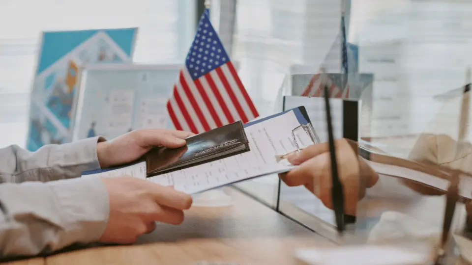 US visa documents and American flag representing H-1B program